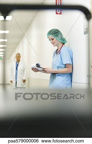 Nurse wearing surgical cap, low angle view View Large Photo Image Stock Photograph - Nurse wearing surgical cap, low angle view. Fotosearch