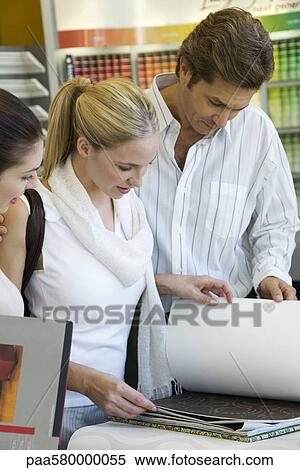 Couple looking at wallpaper samples in store View Large Photo Image Stock Photography - Couple looking at wallpaper samples in store. Fotosearch