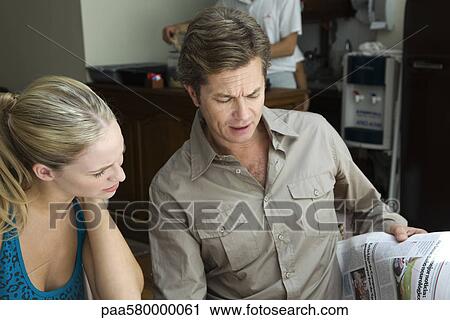 Couple reading newspaper View Large Photo Image Stock Image - Couple reading newspaper. Fotosearch