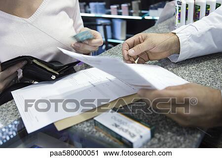 Customer paying for prescription, cropped View Large Photo Image Stock Image - Customer paying for prescription, cropped. Fotosearch