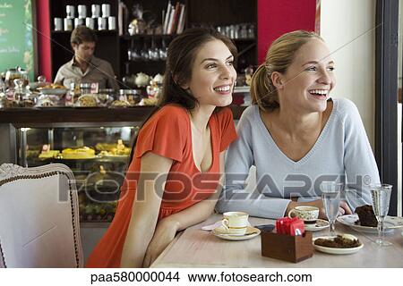 Female friends together at cafe View Large Photo Image Picture - Female friends together at cafe. Fotosearch
