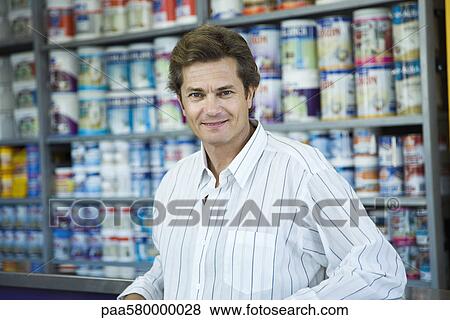 Stock Photo - Man shopping at home improvement store, portrait. Fotosearch