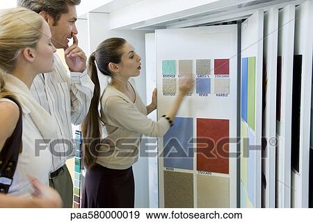 Woman assisting couple choosing color samples in store View Large Photo Image Stock Photo - Woman assisting couple choosing color samples in store. Fotosearch