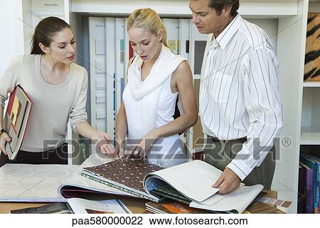 Woman assisting couple choosing wallpaper samples in store View Large Photo Image Stock Image - Woman assisting couple choosing wallpaper samples in store. Fotosearch