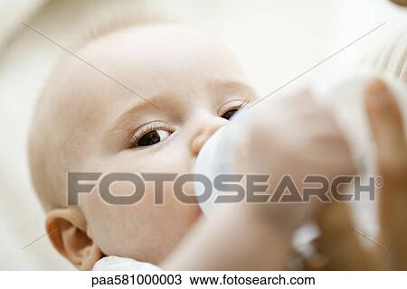 Baby drinking from bottle View Large Photo Image Stock Image - Baby drinking from bottle. Fotosearch