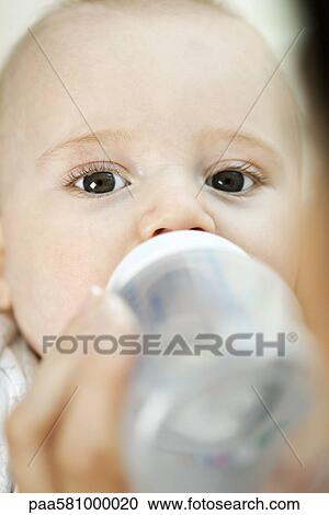 Baby drinking from bottle View Large Photo Image Stock Image - Baby drinking from bottle. Fotosearch