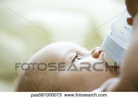 Baby drinking from bottle View Large Photo Image Stock Image - Baby drinking from bottle. Fotosearch