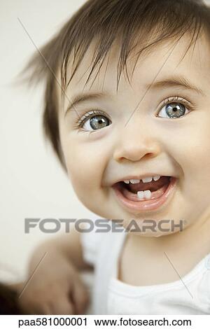Stock Image - Baby girl smiling, portrait. Fotosearch