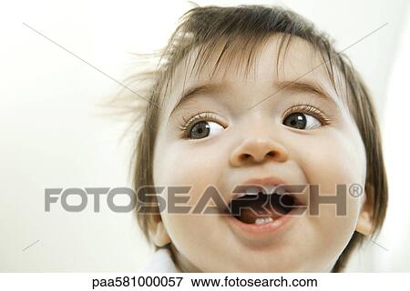 Stock Photo - Baby girl smiling, portrait. Fotosearch
