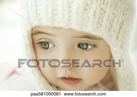 Baby girl wearing knit hat, portrait View Large Photo Image Stock Image - Baby girl wearing knit hat, portrait. Fotosearch