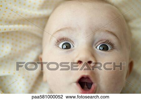 Baby looking at camera with surprised expression, portrait View Large Photo Image Stock Image - Baby looking at camera with surprised expression, portrait. Fotosearch