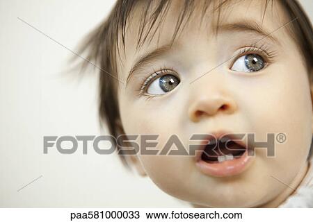 Stock Image - Baby looking away, portrait. Fotosearch