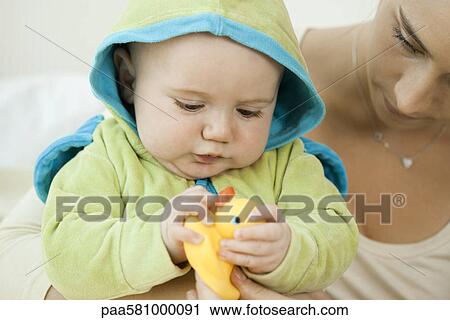 Baby playing with rubber duck before bathtime View Large Photo Image Stock Image - Baby playing with rubber duck before bathtime. Fotosearch