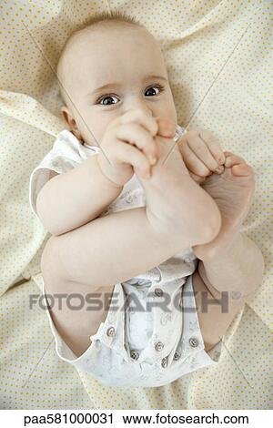 Baby touching its toes View Large Photo Image Stock Image - Baby touching its toes. Fotosearch