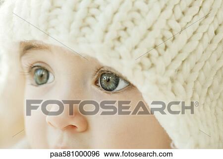 Stock Photograph - Baby wearing knit hat, close-up. Fotosearch