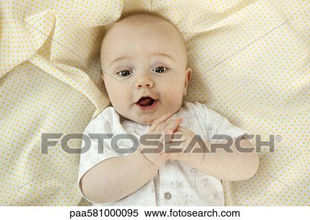 Stock Photography - Baby with suprised expression, portrait. Fotosearch