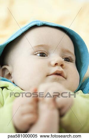 Stock Photography - Infant holding its foot. Fotosearch