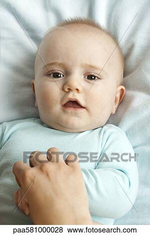 Infant holding mother's hand, portrait View Large Photo Image Stock Photo - Infant holding mother's hand, portrait. Fotosearch