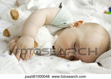 Infant sleeping with stuffed toy View Large Photo Image Stock Photo - Infant sleeping with stuffed toy. Fotosearch