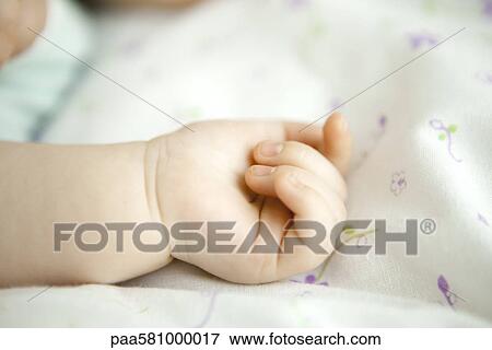 Stock Photo - Infant's hand, close-up. Fotosearch