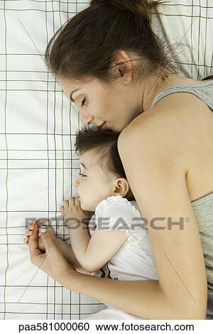 Mother and baby napping together View Large Photo Image Stock Image - Mother and baby napping together. Fotosearch