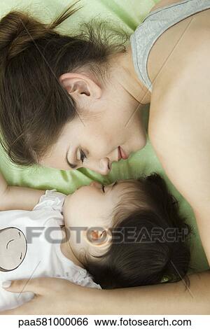 Mother and infant napping together View Large Photo Image Stock Photograph - Mother and infant napping together. Fotosearch