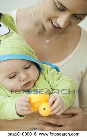 Mother and infant playing with rubber duck before bathtime View Large Photo Image Stock Photograph - Mother and infant playing with rubber duck before bathtime. Fotosearch