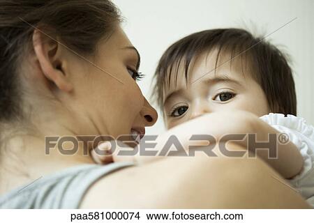Mother holding baby girl View Large Photo Image Picture - Mother holding baby girl. Fotosearch