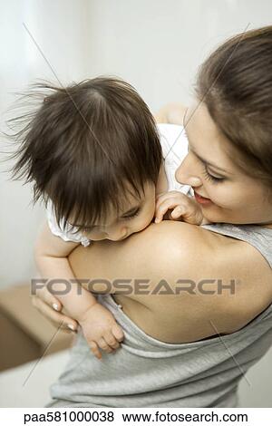 Stock Photo - Mother holding baby girl. Fotosearch