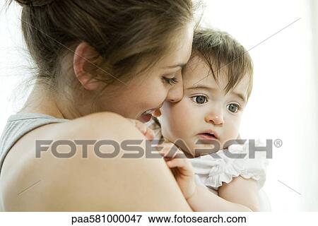 Mother holding baby girl View Large Photo Image Stock Photo - Mother holding baby girl. Fotosearch