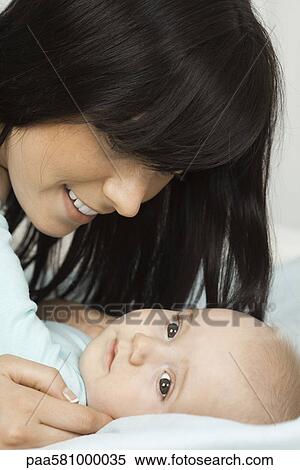 Mother smiling at baby View Large Photo Image Stock Photography - Mother smiling at baby. Fotosearch