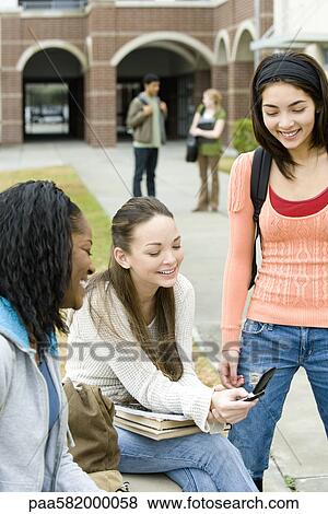Stock Photo - High school friends hanging out together outside of school. Fotosearch
