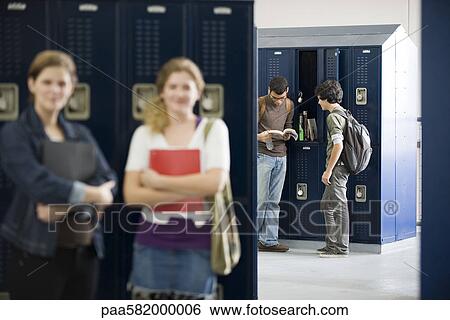 Stock Photograph - High school students chatting by lockers. Fotosearch
