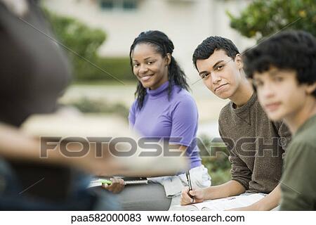 Stock Image - High school students studying outdoors. Fotosearch