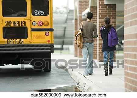 High school students walking toward school bus View Large Photo Image Stock Photo - High school students walking toward school bus. Fotosearch
