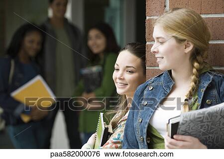 Students chatting together outside school View Large Photo Image Stock Photograph - Students chatting together outside school. Fotosearch
