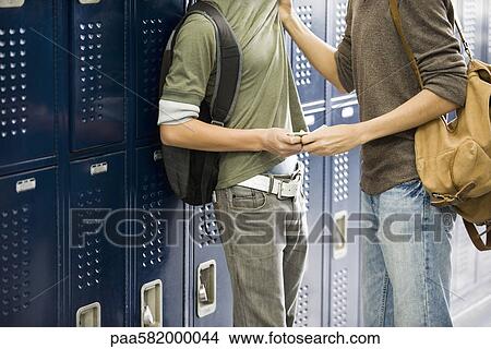 Teenage boy bullying classmate and stealing his money View Large Photo Image Picture - Teenage boy bullying classmate and stealing his money. Fotosearch