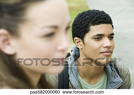 Stock Image - Teenage boy contemplatively looking away. Fotosearch
