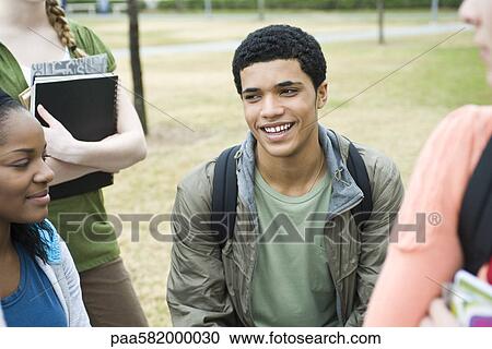 Stock Image - Teenage boy with high school friends, portrait. Fotosearch