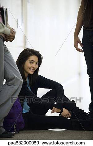 Teenage girl sitting in hallway, portrait View Large Photo Image Stock Photo - Teenage girl sitting in hallway, portrait. Fotosearch