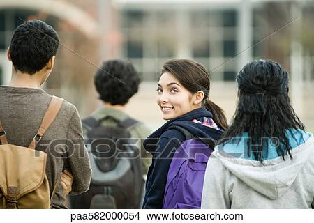 Teenage girl walking with classmates View Large Photo Image Picture - Teenage girl walking with classmates. Fotosearch