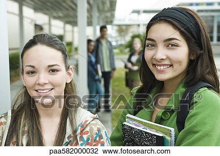 Stock Image - Teenage girl with friend, portrait. Fotosearch