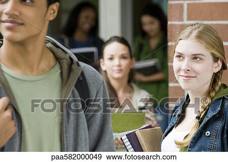Young woman admiring student walking past View Large Photo Image Stock Photo - Young woman admiring student walking past. Fotosearch