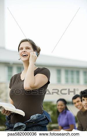 Young woman using cell phone, receiving good news View Large Photo Image Stock Photograph - Young woman using cell phone, receiving good news. Fotosearch