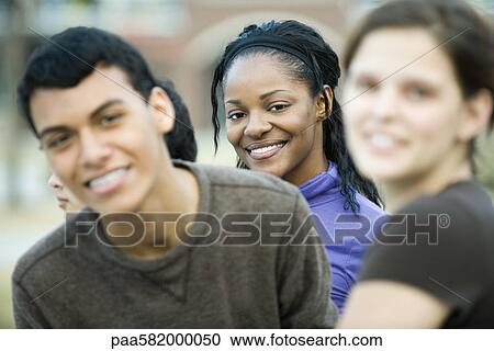 Young woman with friends, portrait View Large Photo Image Stock Image - Young woman with friends, portrait. Fotosearch