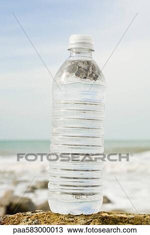 Bottle of water on shore View Large Photo Image Stock Image - Bottle of water on shore. Fotosearch