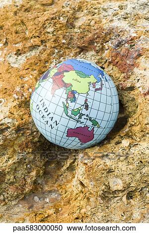 Globe nestled in rock View Large Photo Image Stock Image - Globe nestled in rock. Fotosearch