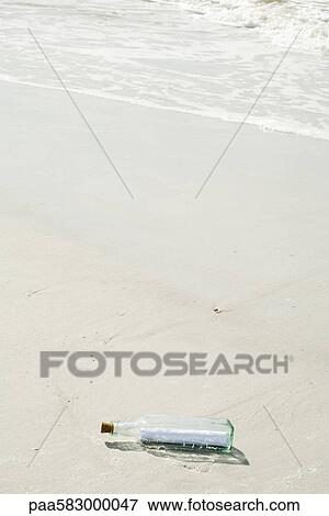 Message in a bottle washed up on beach View Large Photo Image Stock Photo - Message in a bottle washed up on beach. Fotosearch
