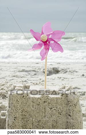 Pinwheel stuck in sand castle View Large Photo Image Stock Image - Pinwheel stuck in sand castle. Fotosearch
