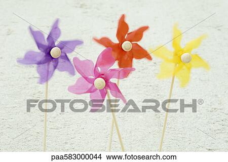 Pinwheels stuck in sand at the beach View Large Photo Image Picture - Pinwheels stuck in sand at the beach. Fotosearch